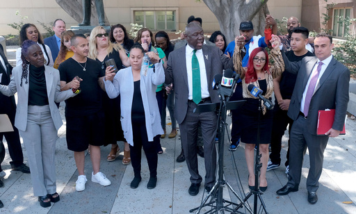 FILE - Attorney Ben Crump, center, leads a chant with attorney Adam Slater, far right, during a news conference with survivors of sexual abuse that occurred at MacLaren Hall, June 9, 2022 in Los Angeles. (Dean Musgrove/The Orange County Register via AP, File) FILE - Attorney Ben Crump, center, leads a chant with attorney Adam Slater, far right, during a news conference with survivors of sexual abuse that occurred at MacLaren Hall, June 9, 2022 in Los Angeles. (Dean Musgrove/The Orange County Register via AP, File)