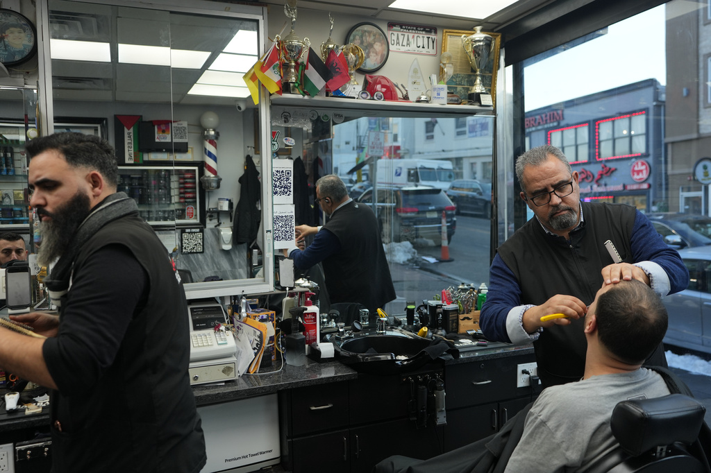 Raed Odeh, the owner and top barber of the Palestine Hair Salon shaves a man in Paterson, N.J., during Ramadan on Friday, Feb. 27, 2026. (AP Photo/Luis Andres Henao)