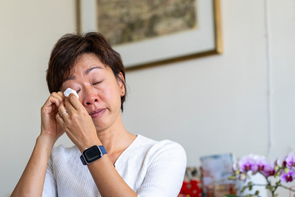 Phyllis Lo, daughter of one of the victims killed by the deadly Wang Fuk Court fire, reacts during an interview at her house in Hong Kong, Friday, Feb. 6, 2026. (AP Photo/Chan Long Hei)