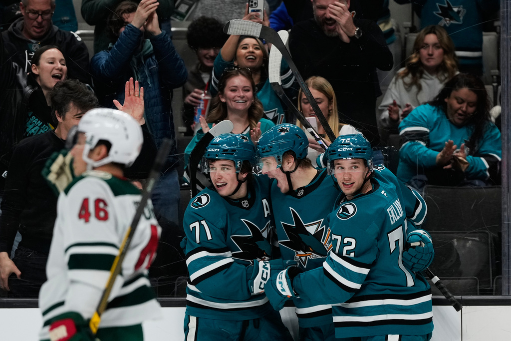 San Jose Sharks center Macklin Celebrini (71) celebrates with left wings Igor Chernyshov (92) and William Eklund (72) after scoring a goal during the third period of an NHL hockey game against the Minnesota Wild, Wednesday, Dec. 31, 2025, in San Jose, Calif. (AP Photo/Godofredo A. Vásquez)