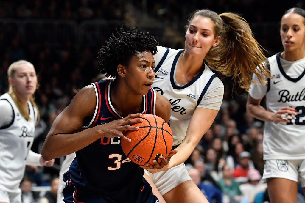 Butler forward Lilly Stoddard, center right, attempts to get the ball away from UConn forward Ayanna Patterson, center left, during the second half of an NCAA college basketball game in Indianapolis, Sunday, Dec. 28, 2025. (AP Photo/Timothy D. Easley)