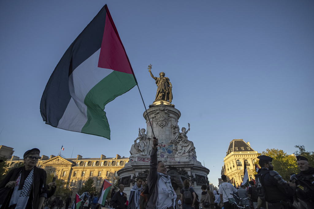 A woman holds a Palestinian flag during a pro-Palestinian gathering at Republic square in Paris, Wednesday, Sep. 17, 2025. (AP Photo/Aurelien Morissard)