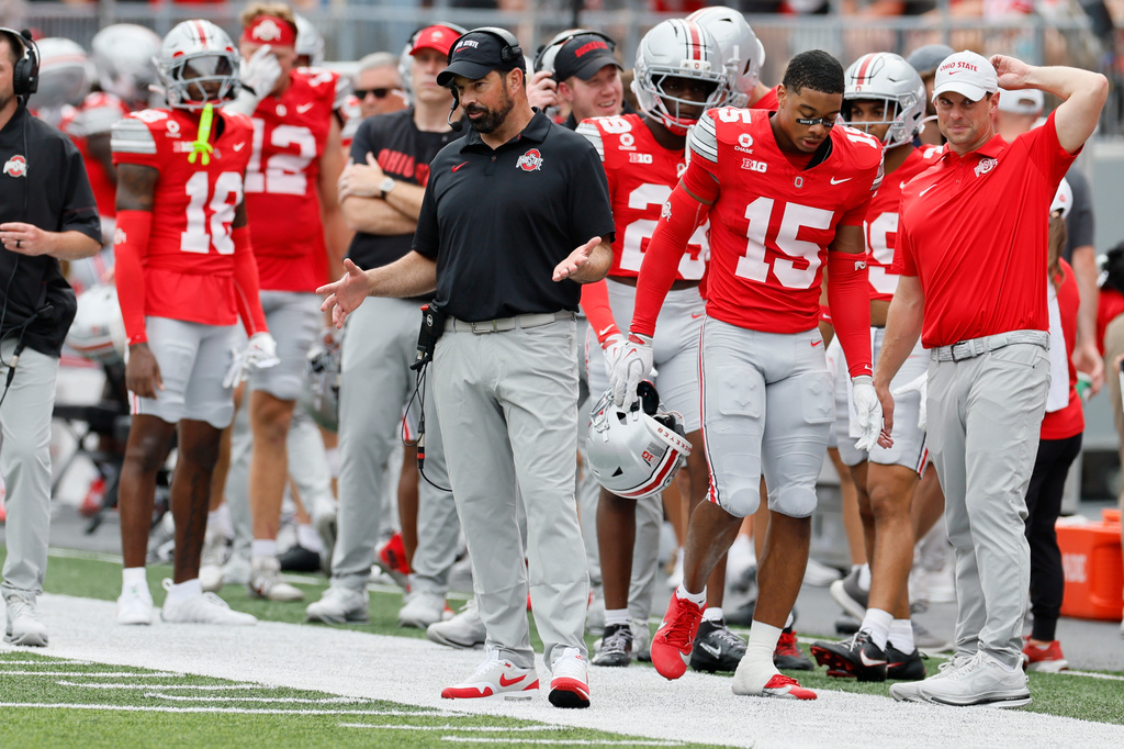 Ohio State head coach Ryan Day, center, watches his team during the second half of an NCAA college football game against Kent State, Saturday, Sept. 19, 2026, in Columbus, Ohio. (AP Photo/Jay LaPrete)