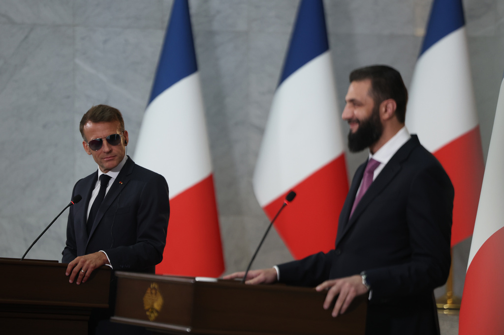 French President Emmanuel Macron, left, listens to Syrian President Ahmad al-Sharaa during a joint press conference at the presidential palace in Damascus, Syria, Tuesday, July 7, 2026. (AP Photo/Ghaith Alsayed)