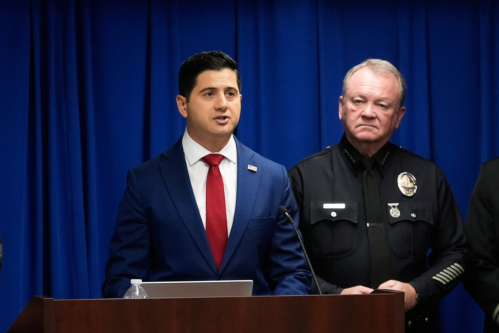 Acting U.S. Attorney Bill Essayli, left, speaks next to Los Angeles Police Chief Jim McDonnell during a news conference announcing an arrest made in the Palisades Fire, Wednesday, Oct. 8, 2025, in Los Angeles. (AP Photo/Damian Dovarganes)
