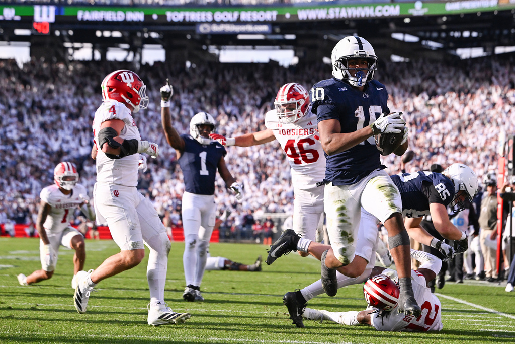 Penn State running back Nicholas Singleton (10) scores a touchdown past Indiana linebacker Aiden Fisher (4) during the fourth quarter of an NCAA college football game, Saturday, Nov. 8, 2025, in State College, Pa. (AP Photo/Barry Reeger)