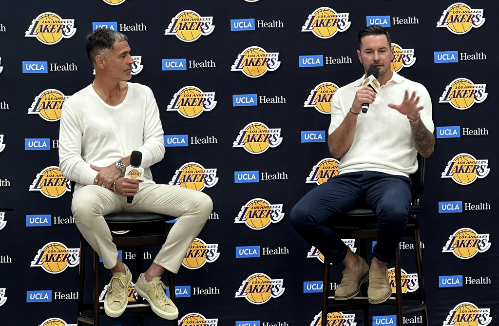 Los Angeles Lakers general manager Rob Pelinka, left and head coach JJ Redick speak with reporters in a news conference at the Lakers' training complex in El Segundo, Calif., on Thursday, Sept. 24, 2026. (AP Photo/Greg Beacham)
