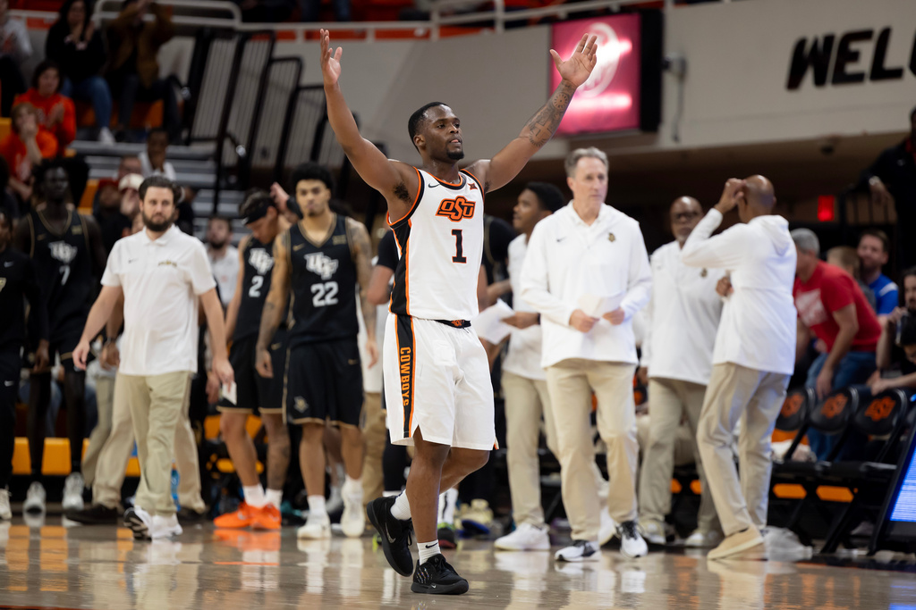 Oklahoma State guard Kanye Clary (1) celebrates in front of the Central Florida bench in the second half of the NCAA college basketball game, Tuesday, Jan. 6, 2026 in Stillwater, Okla. (AP Photo/Mitch Alcala)