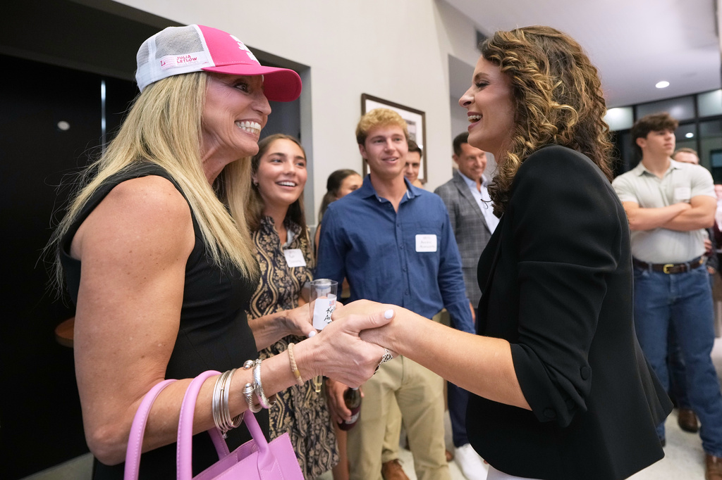 FILE - U.S. Senate candidate Rep. Julia Letlow, R-La., right, speaks with supporters during an election night watch party, May 16, 2026, in Baton Rouge, La. (AP Photo/Matthew Hinton, File)
