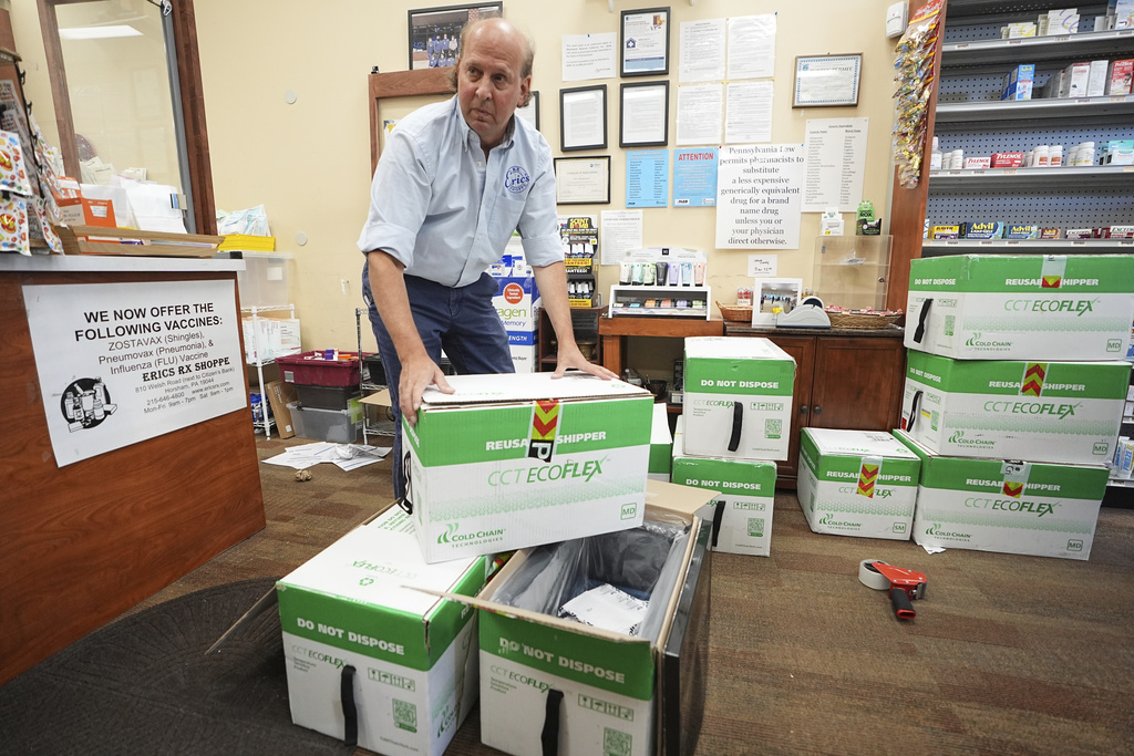 Co-owner Eric Abramowitz at Eric's Rx Shoppe unpacks a shipment of COVID-19 vaccines at the store in Horsham, Pa., Tuesday, Sept. 2, 2025. (AP Photo/Matt Rourke)