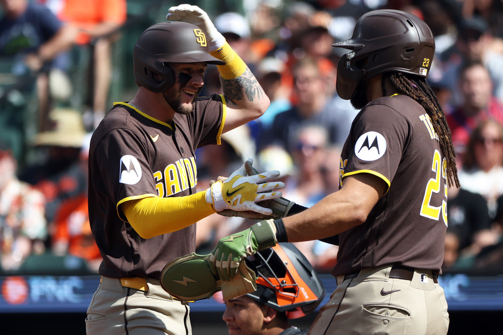 San Diego Padres center fielder Jackson Merrill celebrates with San Diego Padres second baseman Fernando Tatis Jr. after hitting a home run during the first inning of a baseball game against the Baltimore Orioles, Saturday, June 13, 2026, in Baltimore. (AP Photo/Daniel Kucin Jr.)