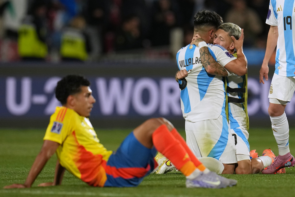 Argentina's Juan Villalba embraces teammate Gianluca Prestianni after they defeated Colombia 1-0 in a FIFA U-20 World Cup semifinal soccer match at the National Stadium in Santiago, Chile, Oct. 15, 2025. (AP Photo/Esteban Felix)