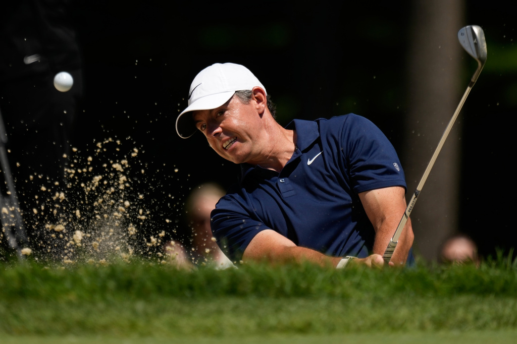 Rory McIlroy, of Northern Ireland, hits out of a bunker on the seventh hole during the first round of the Memorial golf tournament in Dublin, Ohio, Thursday, June 4, 2026. (AP Photo/Sue Ogrocki)