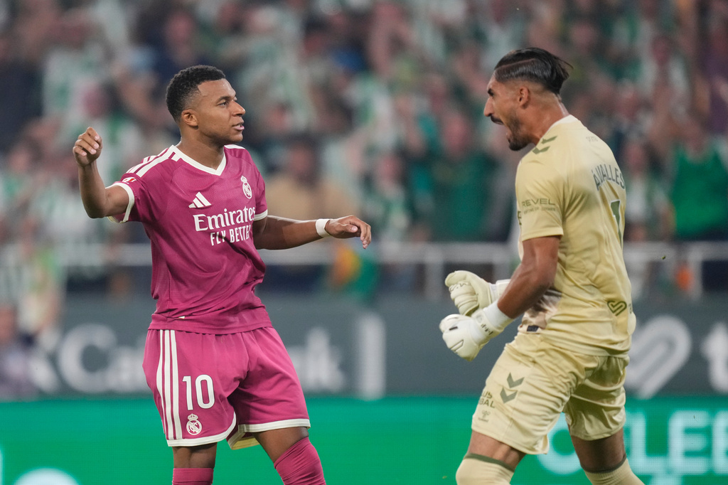 Real Madrid's Kylian Mbappe, left, reacts after missing a penalty kick in front of Betis' goalkeeper Alvaro Valles during the Spanish La Liga soccer match between Real Betis and Real Madrid in Seville, Spain, Friday, Sept. 4, 2026. (AP Photo/Jose Breton)