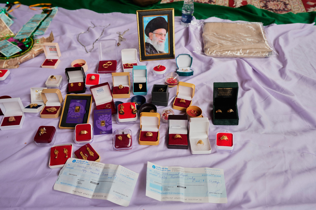 Personal jewelry and cheques are displayed among items collected during a relief drive for Iran in Budgam, Indian-controlled Kashmir, Monday, March 23, 2026. (AP Photo/Mukhtar Khan)