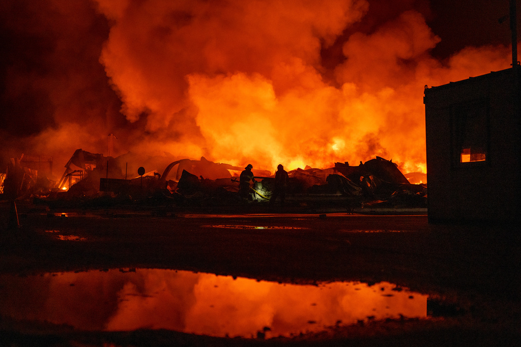 Firefighters put out a fire after Russian missiles hit a warehouse in Kyiv, Ukraine, Wednesday, Aug. 5, 2026. (AP Photo/Dan Bashakov)