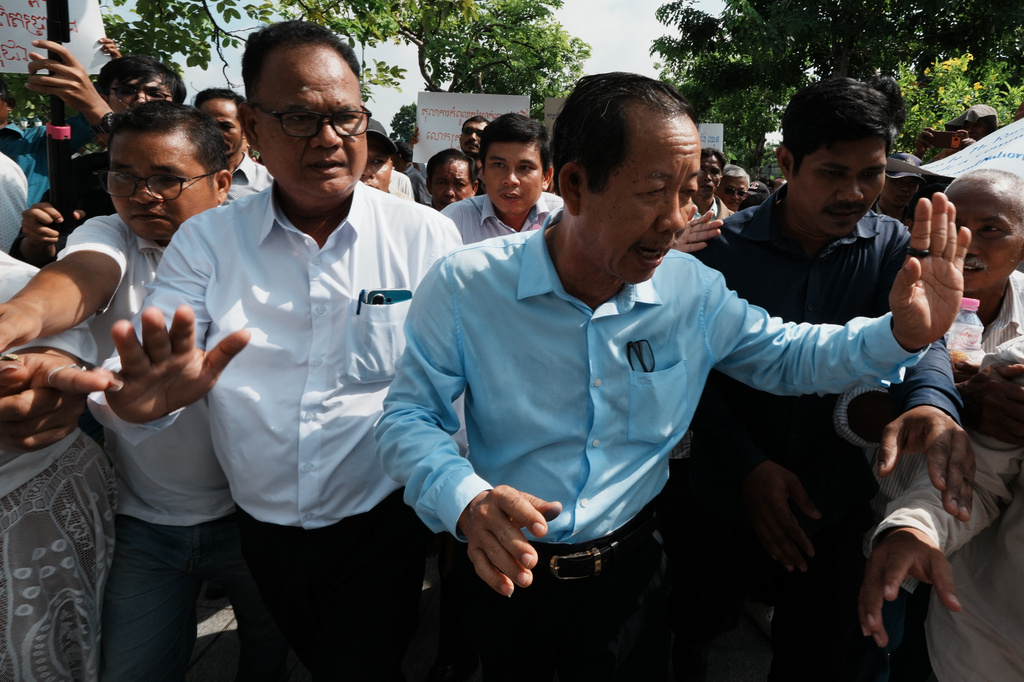 Rong Chhun, a prominent Cambodian opposition politician, right, leaves his Supreme Court hearing in Phnom Penh, Cambodia, Monday, June 15, 2026. (AP Photo/Heng Sinith)