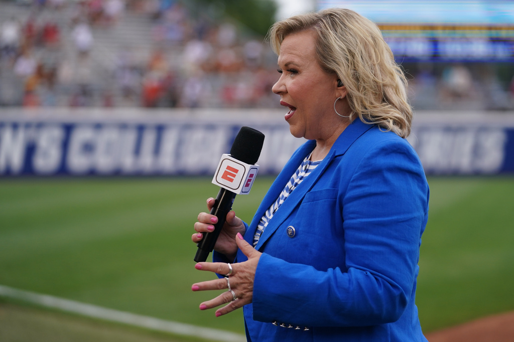 FILE - ESPN's Holly Rowe reports from the field during an NCAA softball Women's College World Series game, Thursday, May 28, 2026 in Oklahoma City. (AP Photo/Vera Nieuwenhuis, File)