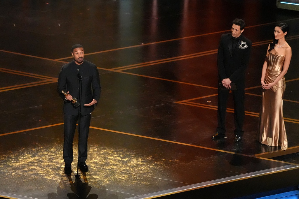 Michael B. Jordan accepts the award for actor in a leading role for "Sinners" during the Oscars on Sunday, March 15, 2026, at the Dolby Theatre in Los Angeles. Adrien Brody looks on from right.(AP Photo/Chris Pizzello)