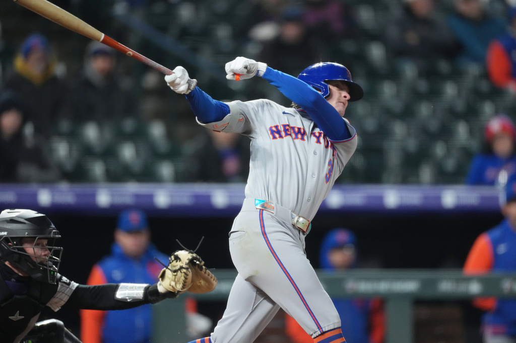 New York Mets' Carson Benge follows the flight of his single to drive in two runs off Colorado Rockies starting pitcher Michael Lorenzen in the fourth inning of a baseball game, Wednesday, May 6, 2026, in Denver. (AP Photo/David Zalubowski)