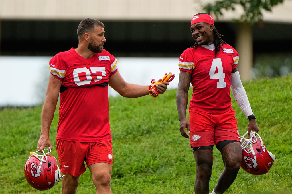 Kansas City Chiefs tight end Travis Kelce (87), and wide receiver Rashee Rice (4) walk to NFL football training camp Friday, July 31, 2026, in St. Joseph, Mo. (AP Photo/Charlie Riedel)