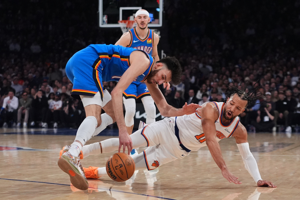 Oklahoma City Thunder's Chet Holmgren (7) fights for control of the ball with New York Knicks' Jalen Brunson (11) during the first half of an NBA basketball game Wednesday, March 4, 2026, in New York. (AP Photo/Frank Franklin II)