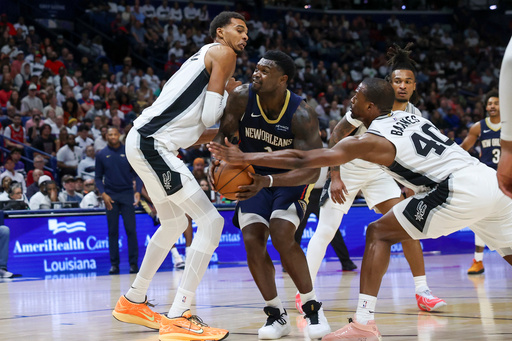 San Antonio Spurs forward Harrison Barnes (40) tries to strip the ball from New Orleans Pelicans forward Zion Williamson (1) as Williamson works against forward Victor Wembanyama (1) during the first half of an NBA basketball game Friday, Oct. 24, 2025, in New Orleans. (AP Photo/Peter Forest) San Antonio Spurs forward Harrison Barnes (40) tries to strip the ball from New Orleans Pelicans forward Zion Williamson (1) as Williamson works against forward Victor Wembanyama (1) during the first half of an NBA basketball game Friday, Oct. 24, 2025, in New Orleans. (AP Photo/Peter Forest)