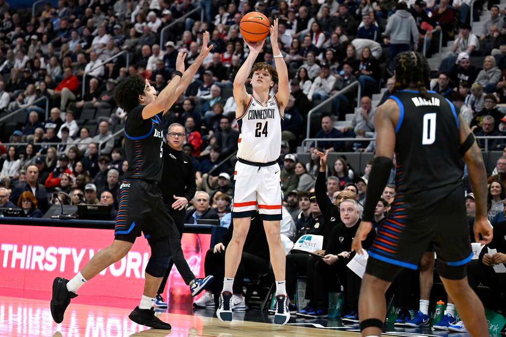 UConn guard Braylon Mullins shoots over DePaul Blue guard RJ Smith, left, in the first half of an NCAA college basketball game, Saturday, Jan. 10, 2026, in Hartford, Conn. (AP Photo/Jessica Hill)