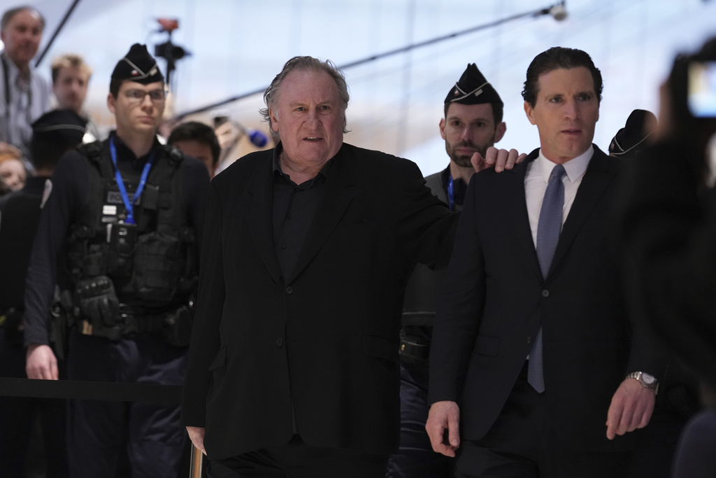 FILE - Actor Gerard Depardieu arrives with his lawyer Jeremie Assous, right, to face trial for the alleged sexual assaults of two women on a film set in 2021, Monday, March 24, 2025 in Paris. (AP Photo/Aurelien Morissard, file)