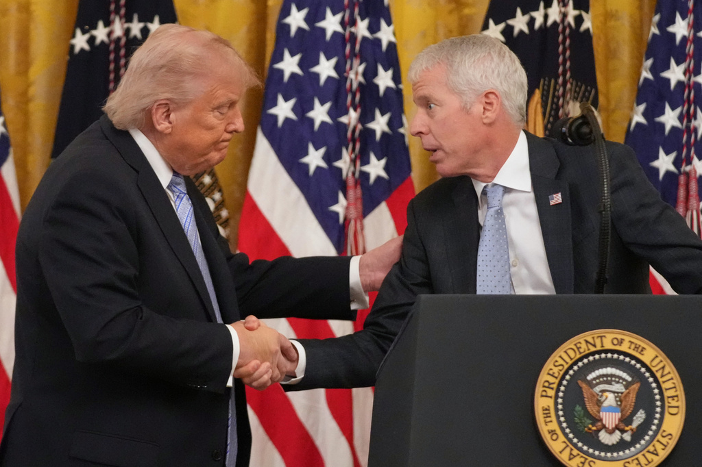 FILE - President Donald Trump shakes hands with Energy Secretary Chris Wright, right, during an event with small business owners May 4, 2026, in the East Room at the White House in Washington. (AP Photo/Mark Schiefelbein, File)