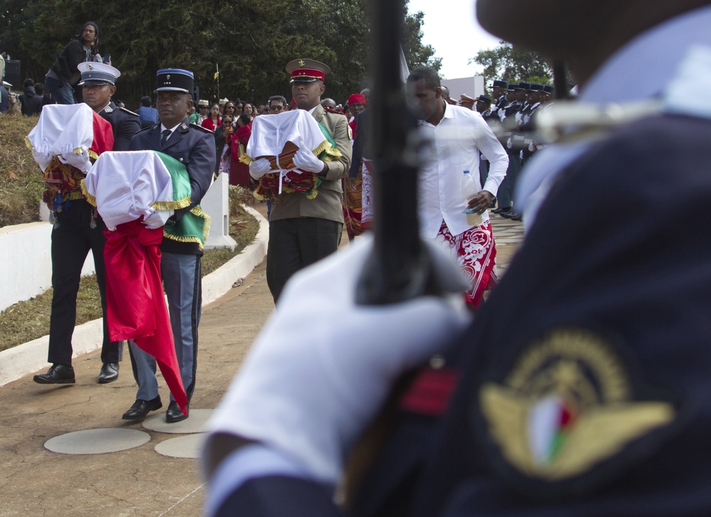 Security servicemen carry the three Sakalava skulls Tuesday, Sept. 2, 2025, in Antananarivo, Madagascar, after they were returned from France where they had been kept for 128 years.(AP Photo/Alexander Joe)