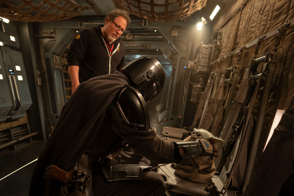 This image released by Disney shows director Jon Favreau, left, and Pedro Pascal on the set of Lucasfilm's "Star Wars: The Mandalorian and Grogu." (Francois Duhamel/Lucasfilm Ltd./Disney via AP)