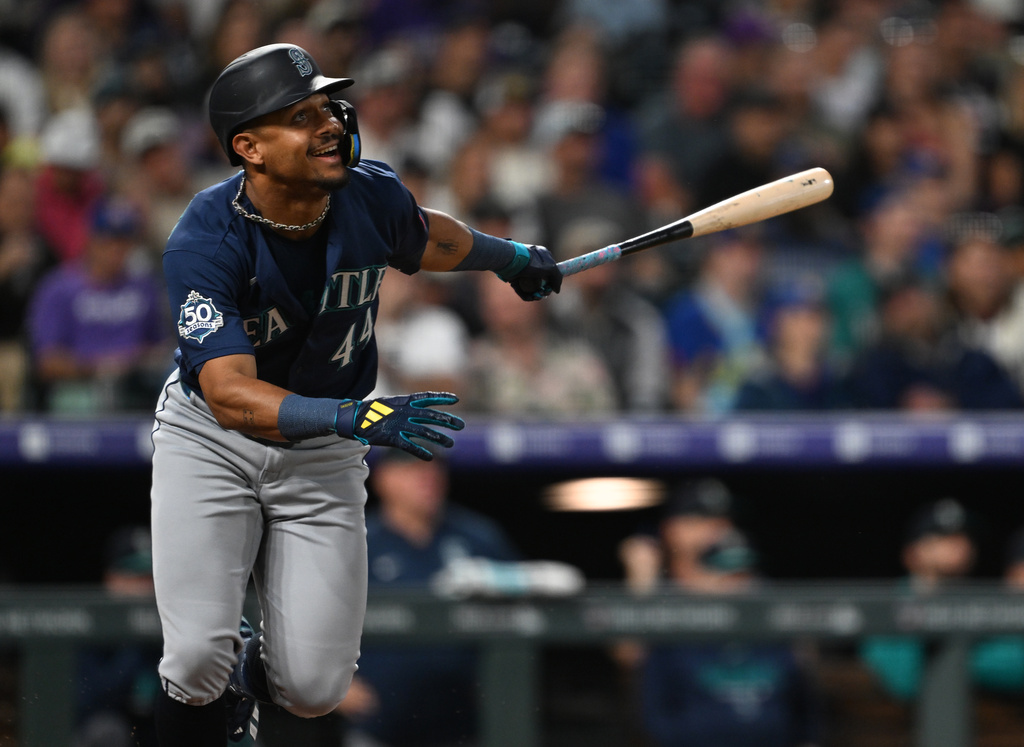 Seattle Mariners center fielder Julio Rodríguez watches his single in the third inning against the Colorado Rockies during a baseball game Saturday, Sept. 19, 2026, in Denver. (AP Photo/RJ Sangosti)