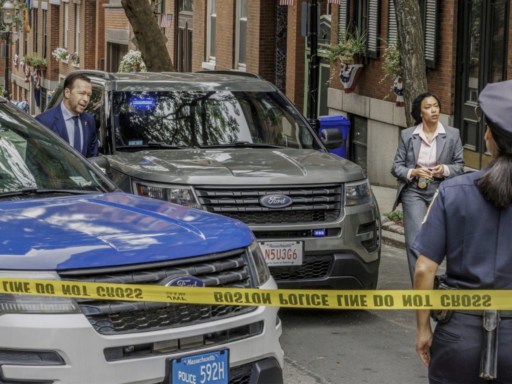 This image released by CBS shows Donnie Wahlberg as Danny Reagan, left, and Sonequa Martin-Green as Lena Silver filming on location in Boston for the series "Boston Blue." (Michele Crowe/CBS via AP)