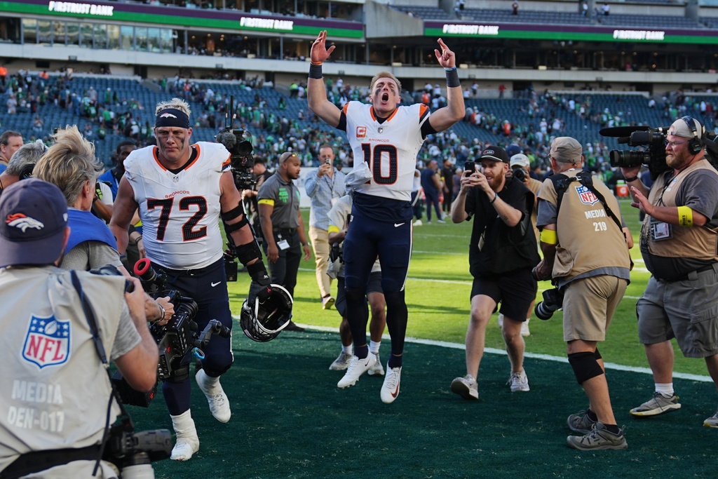 Denver Broncos quarterback Bo Nix (10) celebrates as he leaves the field after an NFL football game against the Philadelphia Eagles on Sunday, Oct. 5, 2025, in Philadelphia. (AP Photo/Matt Rourke)