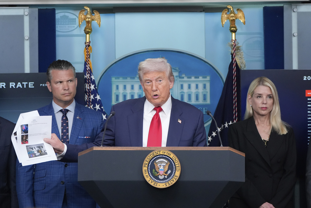President Donald Trump speaks with reporters in the James Brady Press Briefing Room at the White House, Monday, Aug. 11, 2025, in Washington, as Secretary of Defense Pete Hegseth and Attorney General Pam Bondi look on. (AP Photo/Alex Brandon)