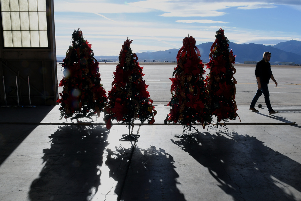 Christmas trees are displayed inside a hangar at Peterson Space Force Base in Colorado Springs, Colo., on Thursday, Dec. 18, 2025 in advance of the annual NORAD Tracks Santa Operation, at the North American Aerospace Defense Command. (AP Photo/Thomas Peipert)