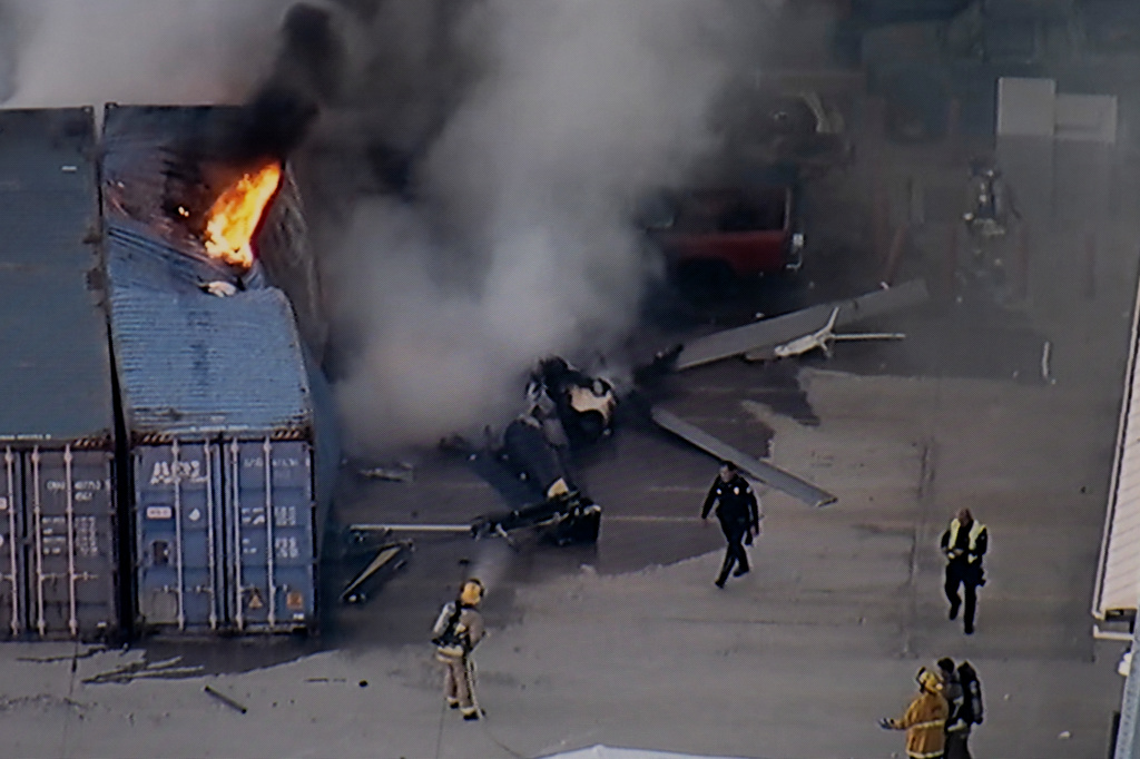 In this still image provided by KABC-TV shows first responders work the scene after a helicopter crashed near a bus crash in Chatsworth, a neighborhood in Los Angeles, Tuesday, Sept. 15, 2026. (KABC-TV via AP)