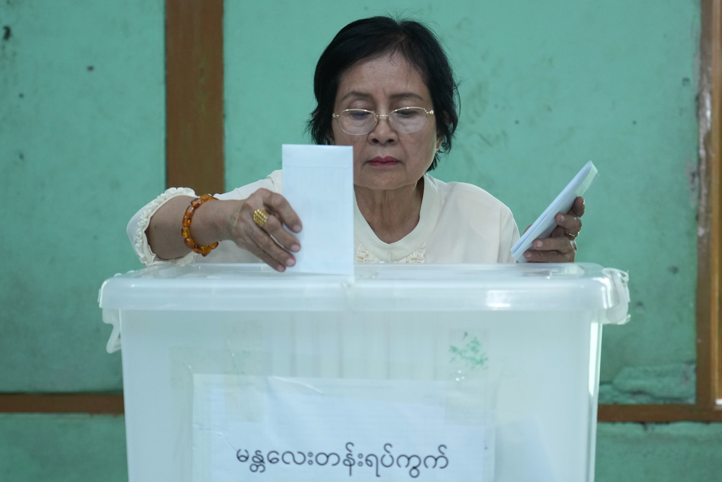 A woman casts her advanced ballot at polling station opened at a school in Pyawbwe Township, Mandalay Division, central Myanmar, Thursday, Dec. 25, 2025. (AP Photo/Aung Shine Oo)