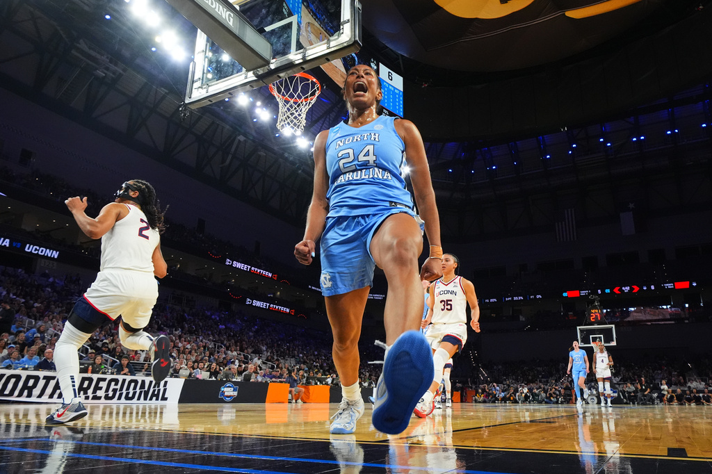 North Carolina guard Indya Nivar (24) celebrates after blocking a shot attempt by UConn guard KK Arnold (2) in the first half in the Sweet 16 of the NCAA college basketball tournament, Friday, March 27, 2026, in Fort Worth, Texas. (AP Photo/Julio Cortez)