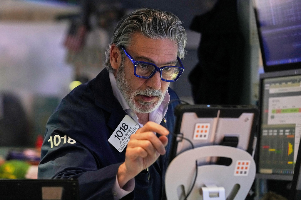 Trader John Romolo works on the floor of the New York Stock Exchange, Monday, Jan. 12, 2026. (AP Photo/Richard Drew)