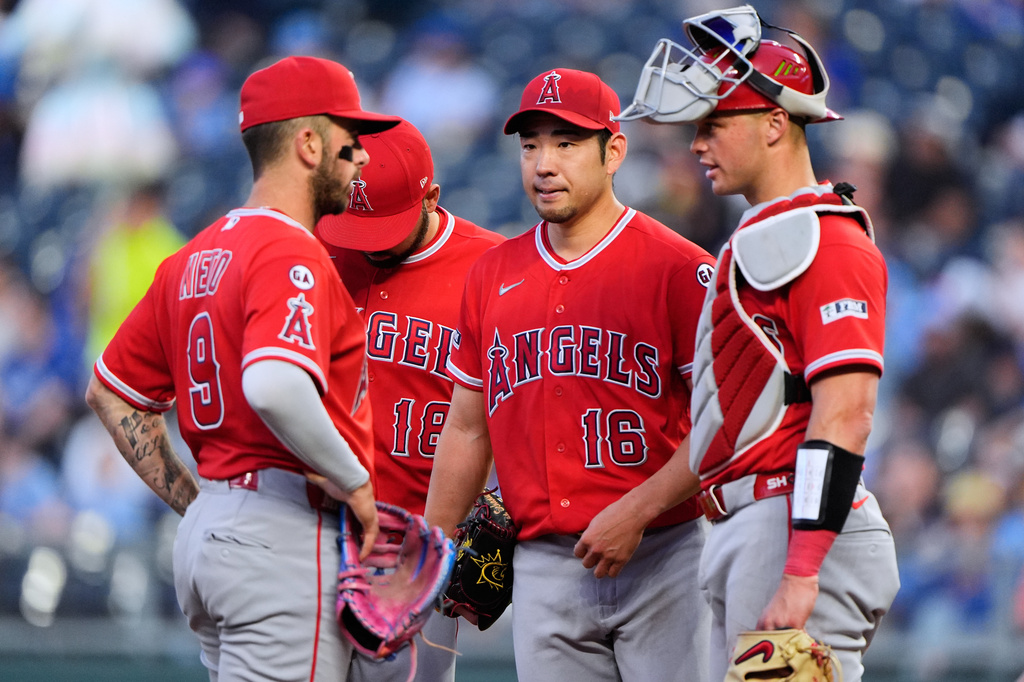 Los Angeles Angels starting pitcher Yusei Kikuchi meets on the mound with teammates during the fourth inning of a baseball game against the Kansas City Royals, Friday, April 24, 2026, in Kansas City, Mo. (AP Photo/Charlie Riedel)