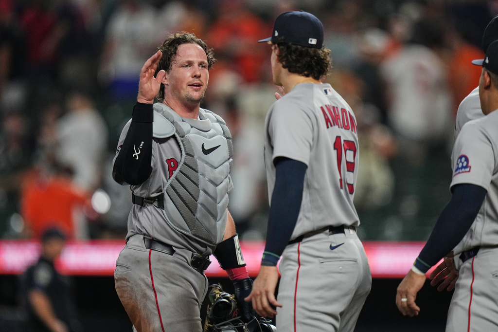 Boston Red Sox catcher Adley Rutschman, left, and left fielder Roman Anthony, center, celebrate their team's victory over the Baltimore Orioles in a baseball game, Thursday, Sept. 3, 2026, in Baltimore. (AP Photo/Stephanie Scarbrough)