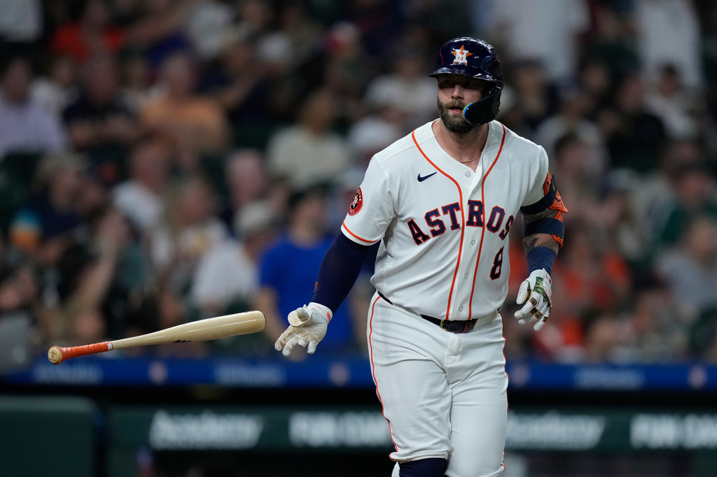 Houston Astros' Christian Walker tosses his bat after hitting a solo home run during the second inning of a baseball game against the Colorado Rockies, Tuesday, April 14, 2026, in Houston. (AP Photo/Kevin M. Cox)