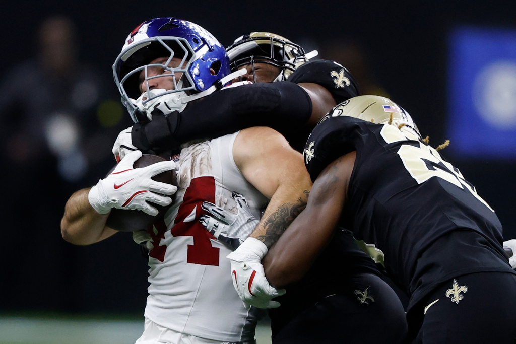 New York Giants running back Cam Skattebo (44) is hit by New Orleans Saints defensive end Chris Rumph II (58) in the second half of an NFL football game, Sunday, Oct. 5, 2025, in New Orleans. (AP Photo/Butch Dill)