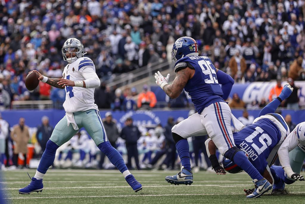 Dallas Cowboys quarterback Dak Prescott (4) passes under pressure against the New York Giants during the second quarter of an NFL football game, Sunday, Jan. 4, 2026, in East Rutherford, N.J. (AP Photo/Adam Hunger)