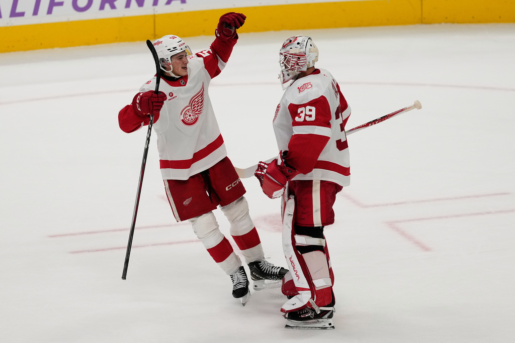Detroit Red Wings center Emmitt Finnie, left, celebrates with goaltender Cam Talbot after the Red Wings defeated the San Jose Sharks following a shootout of an NHL hockey game in San Jose, Calif., Sunday, Nov. 2, 2025. (AP Photo/Jeff Chiu)