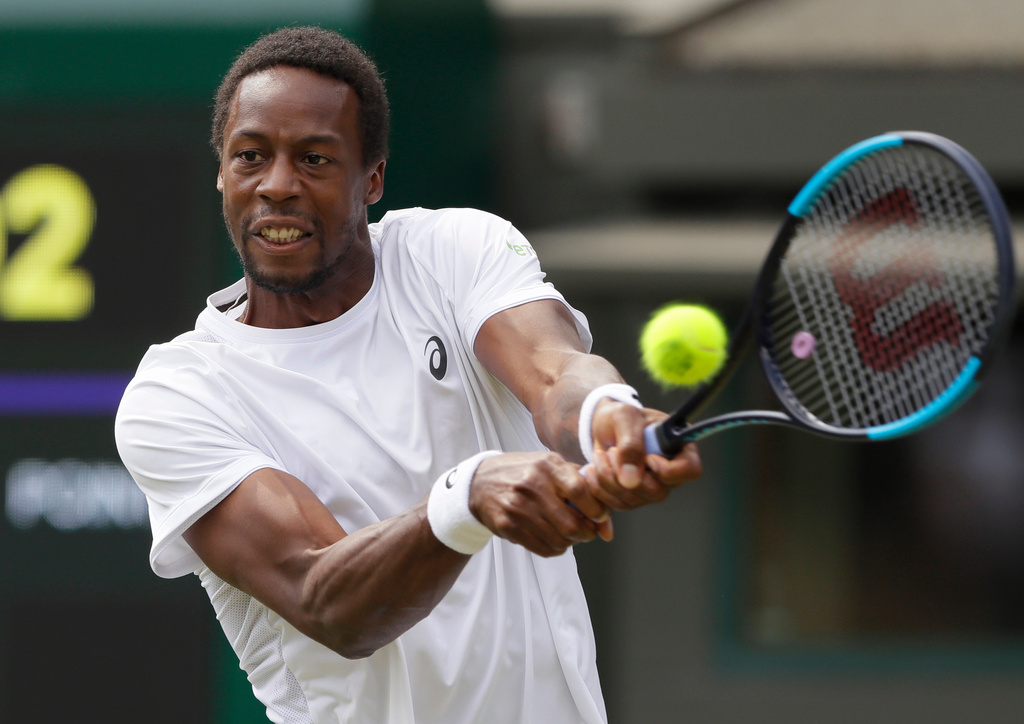 FILE- Gael Monfils of France returns the ball to Kevin Anderson of South Africa during their men's singles match on the seventh day at the Wimbledon Tennis Championships in London, July 9, 2018. (AP Photo/Kirsty Wigglesworth, File)