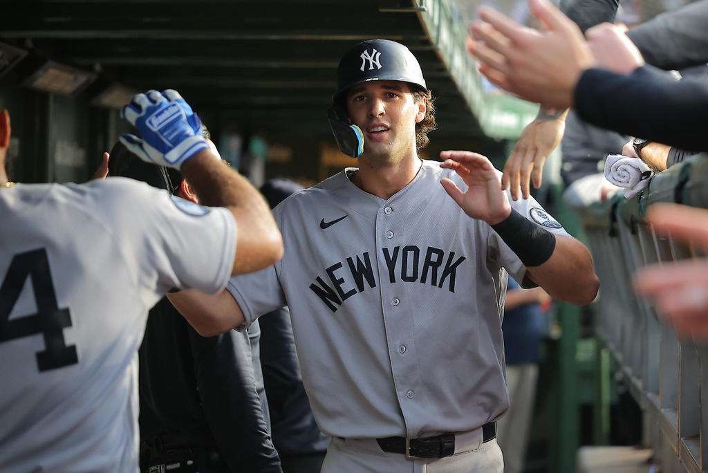New York Yankees' Spencer Jones celebrates in the dugout after scoring on teammate José Caballero's RBI single during the fifth inning of a baseball game against the Chicago Cubs, Saturday, Aug. 1, 2026, in Chicago. (AP Photo/Melissa Tamez)