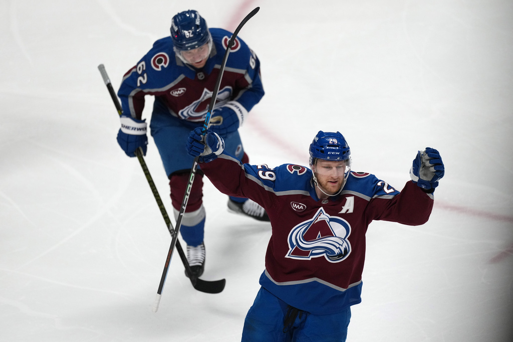 Colorado Avalanche center Nathan MacKinnon, front, and left wing Artturi Lehkonen react after center Martin Necas scored a goal against the Minnesota Wild in the first period of Game 2 of an NHL hockey Stanley Cup second-round playoff series Tuesday, May 5, 2026, in Denver. (AP Photo/David Zalubowski)